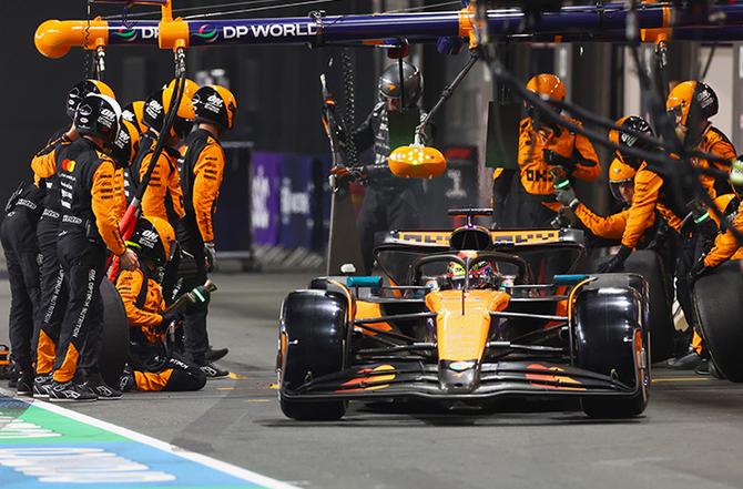 A McLaren car driving away after a pitstop