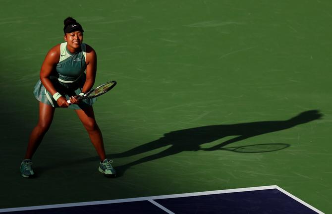Naomi Osaka of Japan waits to return serve against Sara Errani of Italy in their first round match during the BNP Paribas Open at Indian Wells Tennis Garden