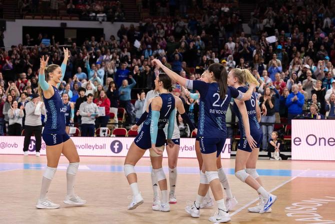 LOVB volleyball players celebrating on the court