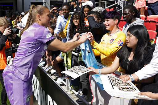 Washington Spirit goalkeeper Aubrey Kingsbury (1) signs one of her souvenir goalkeeper jerseys for a fan after the match against NJ/NY Gotham FCat Audi Field.