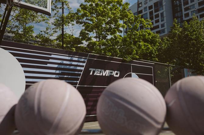 Basketballs on the ground in front of a Toronto Tempo sign