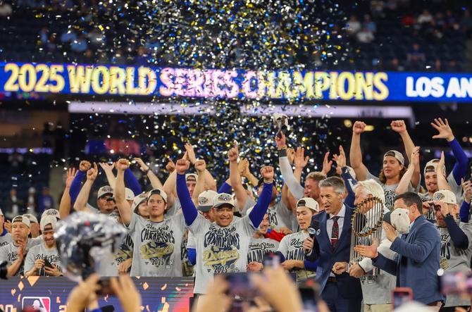 Manager Dave Roberts of the Los Angeles Dodgers celebrates with his team after defeating the Toronto Blue Jays 5-4 to win the 2025 World Series.