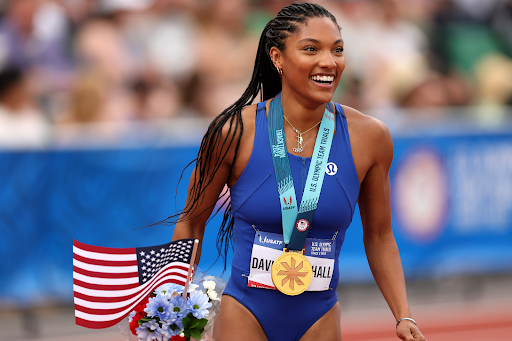 Long jumper Tara Davis-Woodhall smiles after winning a gold medal at the Paris 2024 Olympics.
