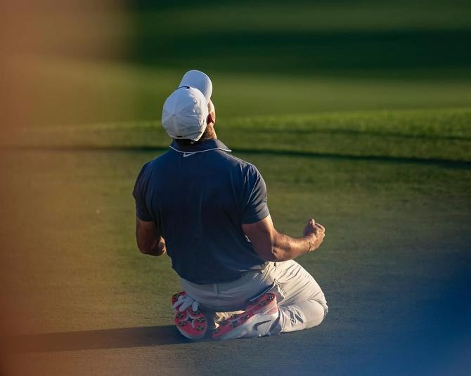 Rory McIlroy falls to the ground after winning the Masters.