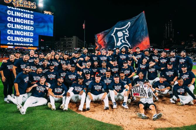 Detroit Tigers players celebrate on the field after clinching a playoff berth