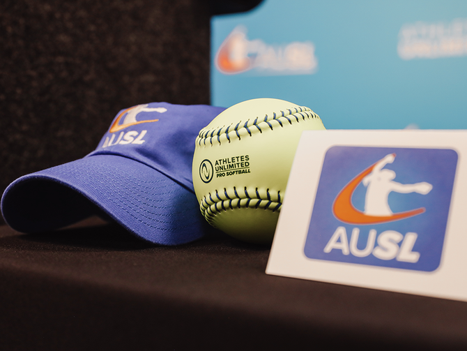 Athletes Unlimited displays AUSL hat, softball, and logo.