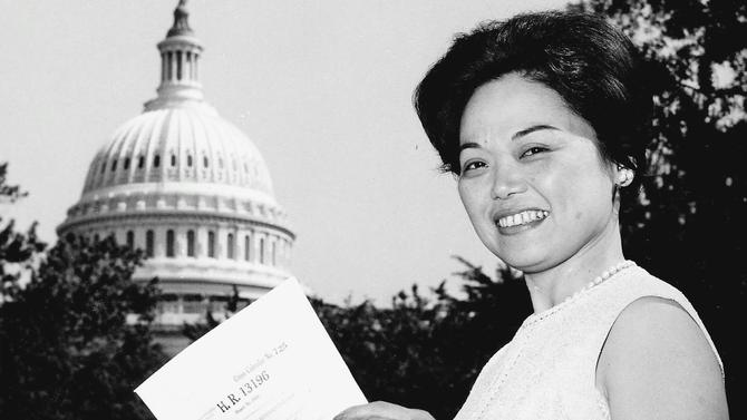 U.S. Representative Patsy T. Mink poses outside the Capitol Building with a copy of H.R. 13196, the bill which eventually became Title IX.