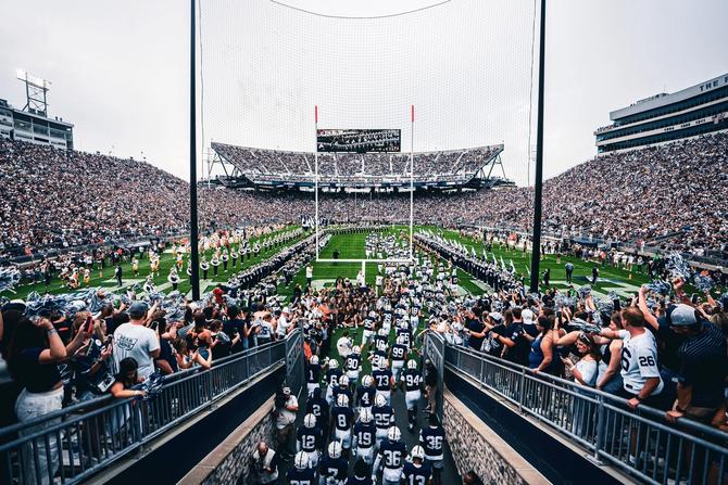The Penn State football team runs out of the tunnel before a game at Beaver Stadium.