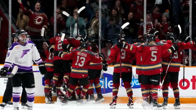 Ottawa Charge players celebrate Emily Clark's game-winning goal in overtime during Game 1 of the PWHL Finals against the Minnesota Frost on Tuesday.