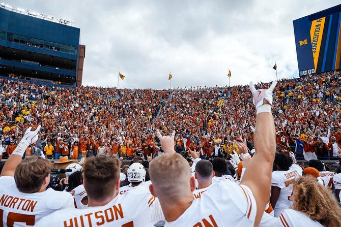 Members of the Texas Longhorns football team celebrate with their fans after the win against Michigan.