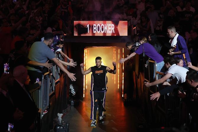 Devin Booker high fiving fans