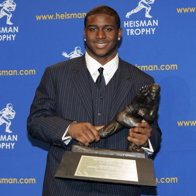 USC football alum Reggie Bush poses with his Heisman Trophy at the 2005 awards ceremony