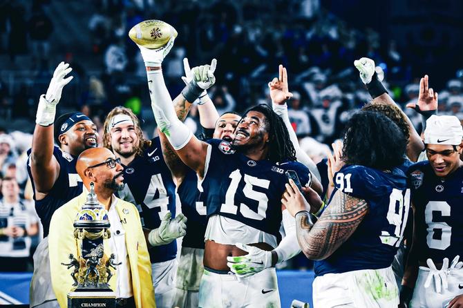 The Penn State football team poses with the trophy after winning the Fiesta Bowl.