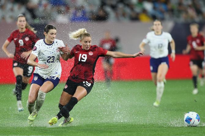 CanWNT forward Adriana Leon is marked by USWNT defender Emily Fox.
