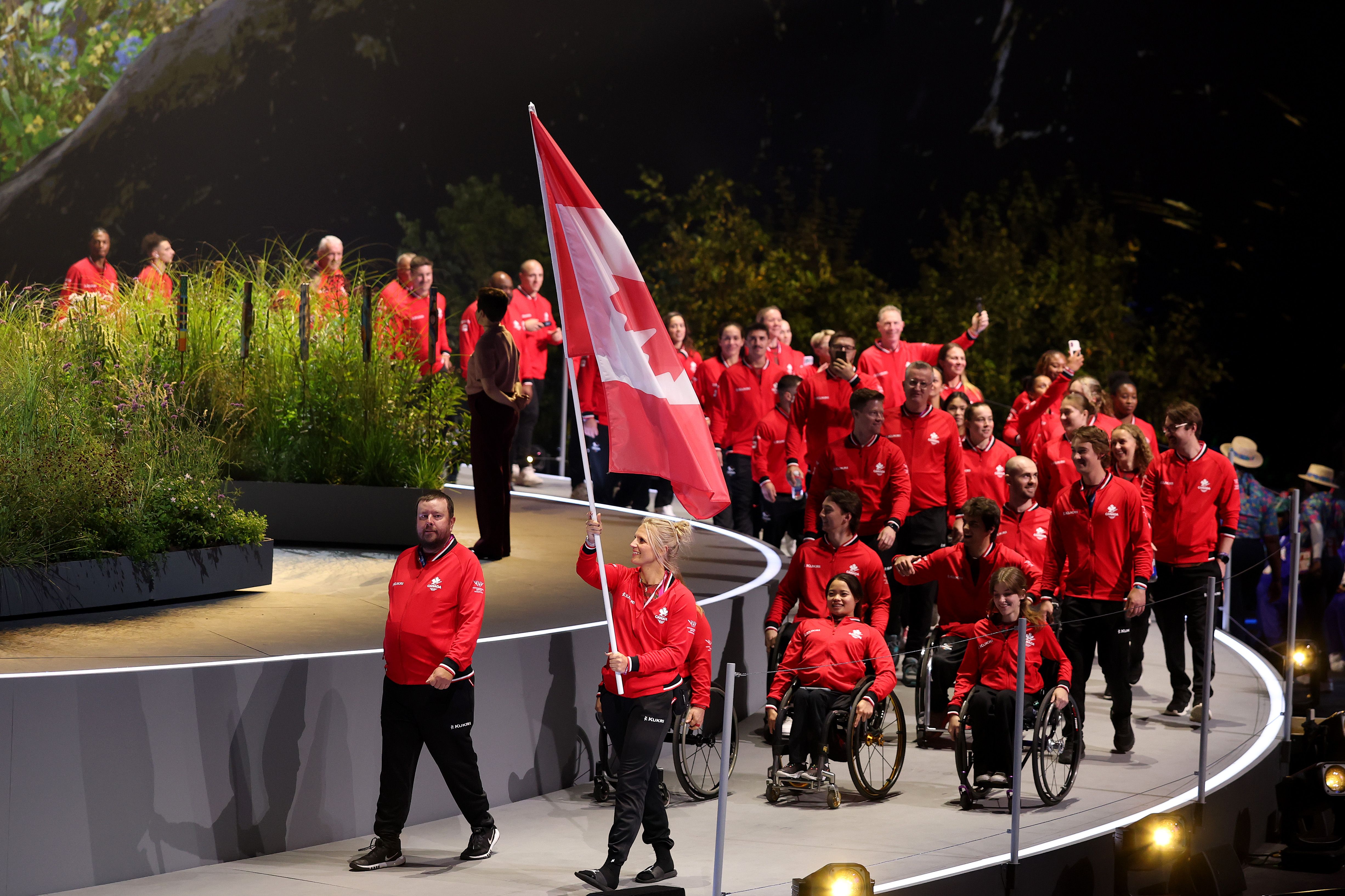 Team Canada’s Kady Dandeneau and Ryan Bester lead their teammates into the opening ceremonies of the 2026 Commonwealth Games.