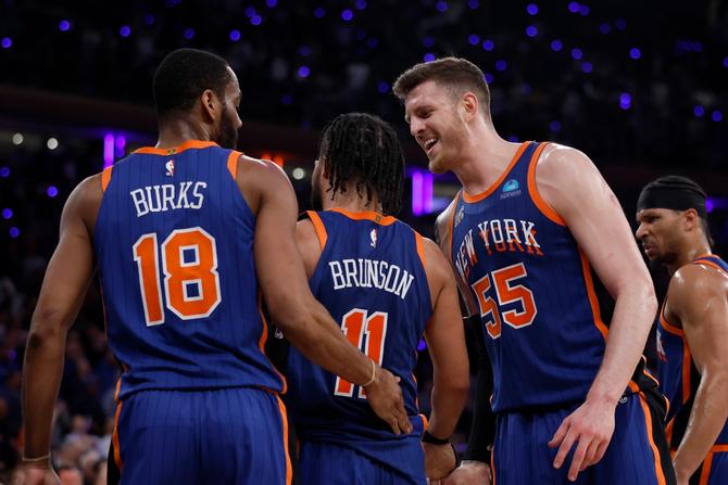 Jalen Brunson #11, Isaiah Hartenstein #55, and Alec Burks #18 of the New York Knicks react during the fourth quarter against the Indiana Pacers.