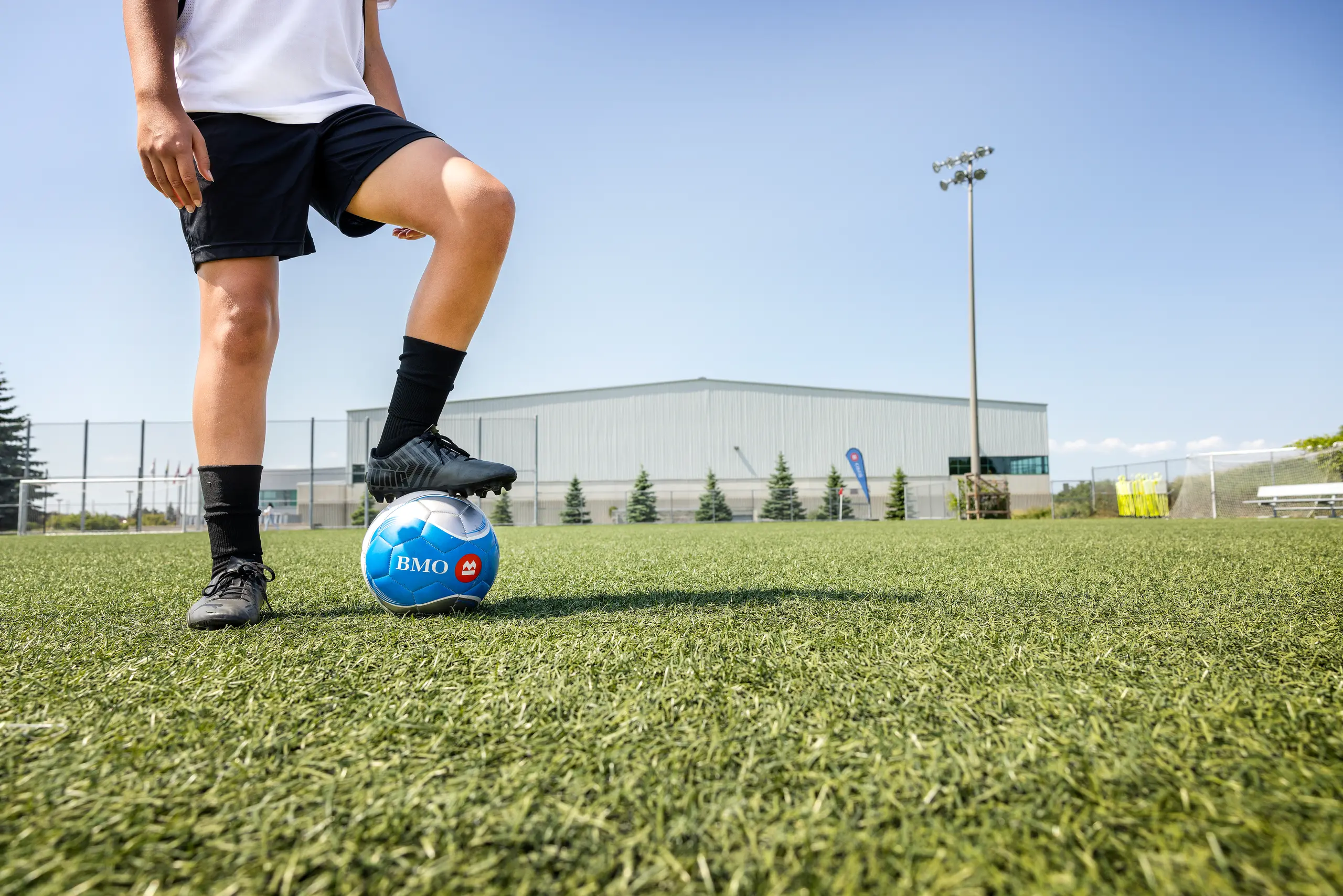 A soccer player with their foot on a soccer ball