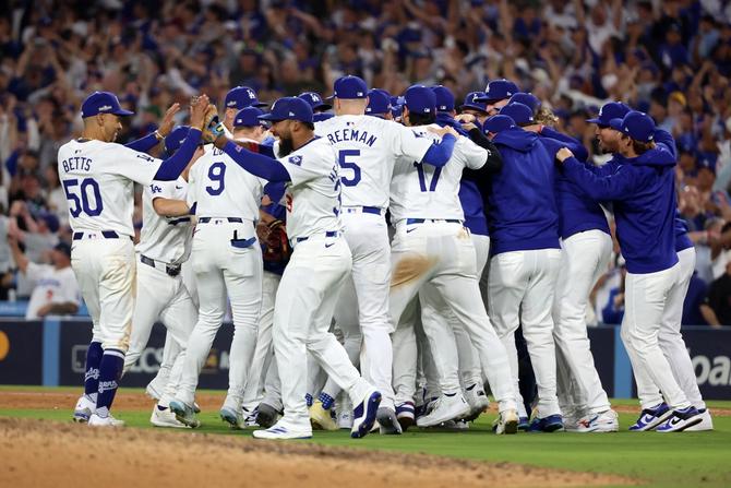 The Los Angeles Dodgers celebrate as they defeat the New York Mets to win Game Six of the National League Championship Series at Dodger Stadium