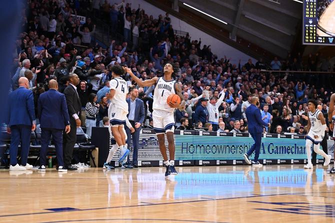 Villanova men’s basketball players and fans celebrate after the team upset No. 9 UConn.