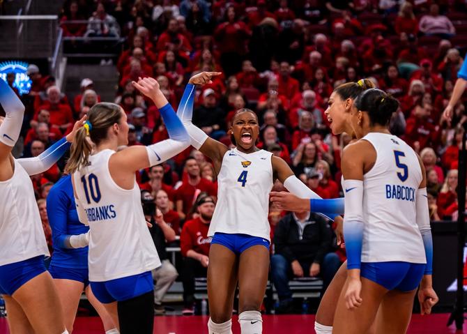 Pittsburgh volleyball players celebrate after scoring a point.