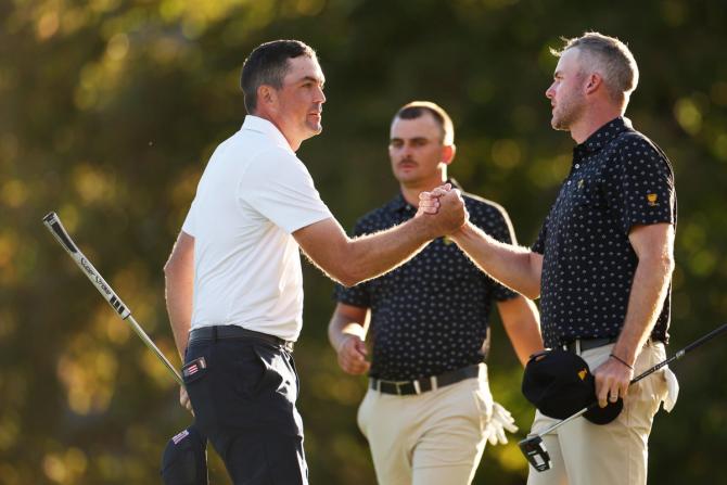 Keegan Bradley of the U.S. Team shakes hands with Taylor Pendrith of Canada and the International Team