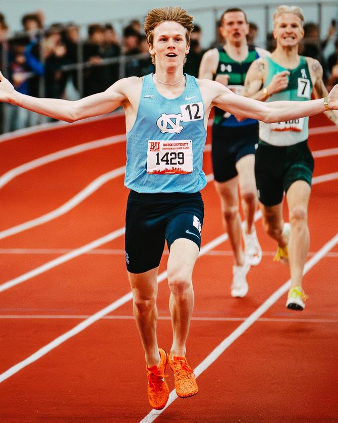 North Carolina senior Ethan Strand crosses the finish line after setting the men’s indoor mile record.