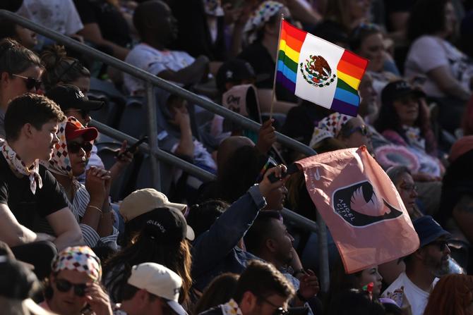 Fans hold flags celebrating Pride Night during a game between the Houston Dash and Angel City FC at BMO Stadium on June 25, 2023 in Los Angeles, California.