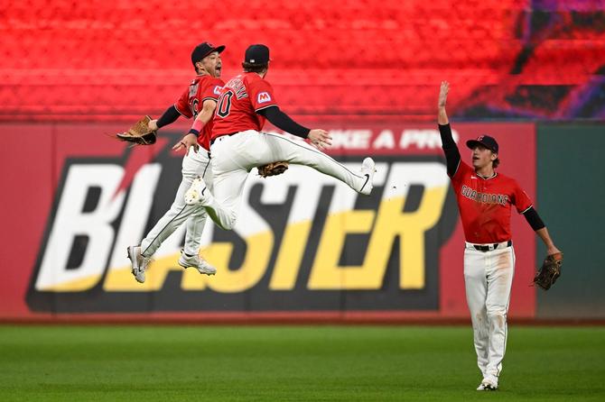 Cleveland Guardians players celebrating on the field after beating the Detroit Tigers