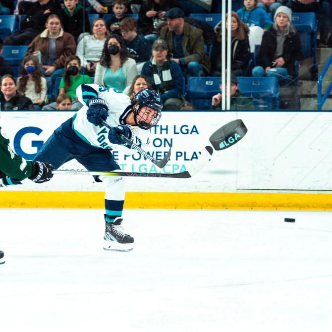 Alex Carpenter taking a shot against a defender