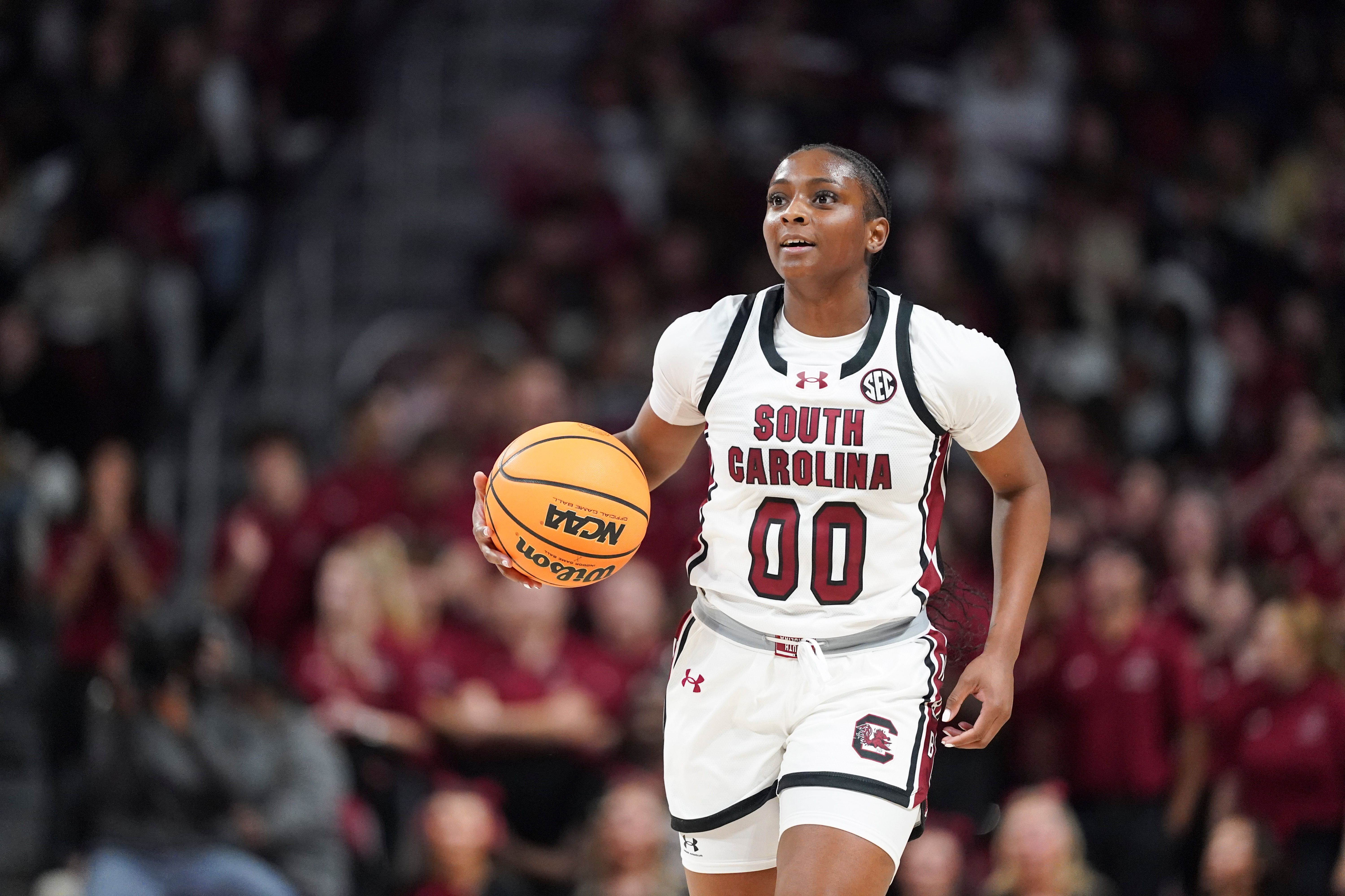 Ta'Niya Latson dribbles