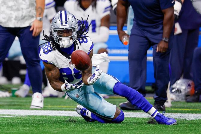 Dallas Cowboy CeeDee Lamb makes a sliding catch during yesterday’s game against the Atlanta Falcons.