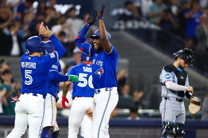 Toronto Blue Jays outfielder Jesús Sanchez celebrates with teammate Daulton Varsho after hitting his first-ever career grand slam.