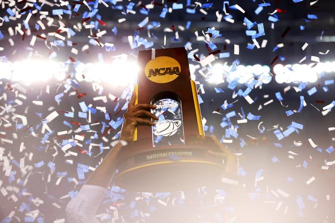 The Connecticut Huskies celebrate with the trophy after defeating the Kentucky Wildcats 60-54 in the NCAA Men's Final Four Championship at AT&T Stadium on April 7, 2014 in Arlington, Texas.