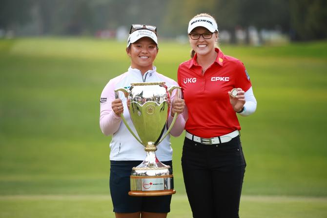 Megan Khang of the United States and Brooke M. Henderson of Canada pose together on the 18th green after the CPKC Women's Open at Shaughnessy Golf and Country Club on August 27, 2023.