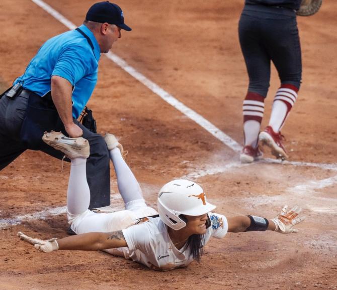 No. 1–seed Texas softball second baseman Alyssa Washington calls herself safe as she slides into home during the Longhorns’ 1–0 win over No. 8 Stanford on Monday.