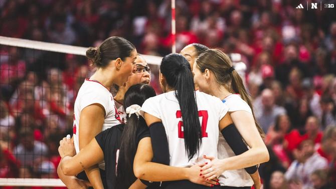 The Nebraska women’s volleyball team huddles up after a point.