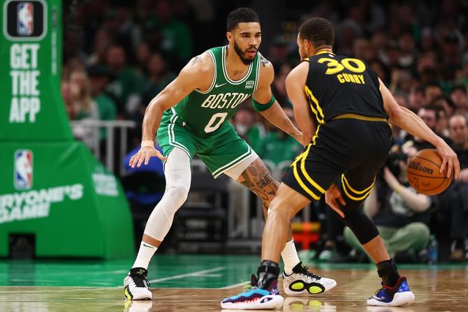 Jayson Tatum #0 of the Boston Celtics defends Stephen Curry #30 of the Golden State Warriors.