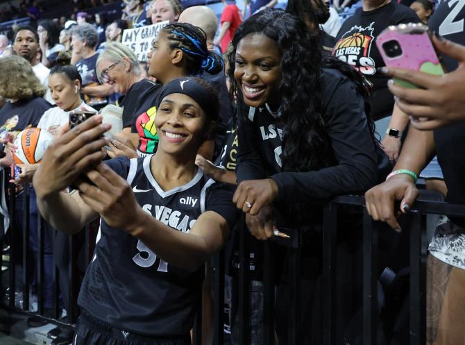 Sydney Colson #51 of the Las Vegas Aces poses for photos with fans after the team's 94-83 victory over the Seattle Storm at Michelob ULTRA Arena on June 19, 2024 in Las Vegas, Nevada.