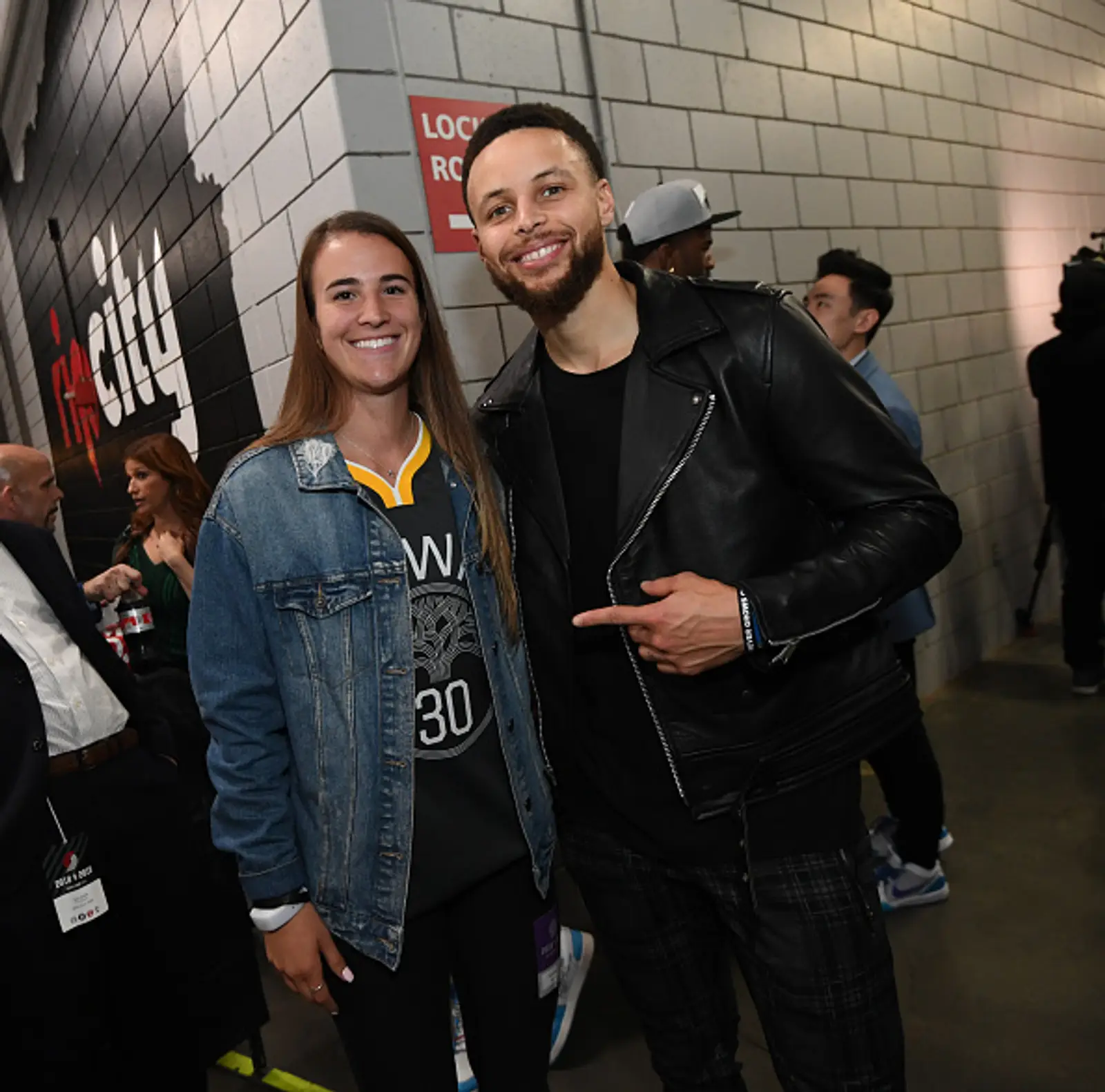 Sabrina Ionescu and Steph Curry posing for a photo