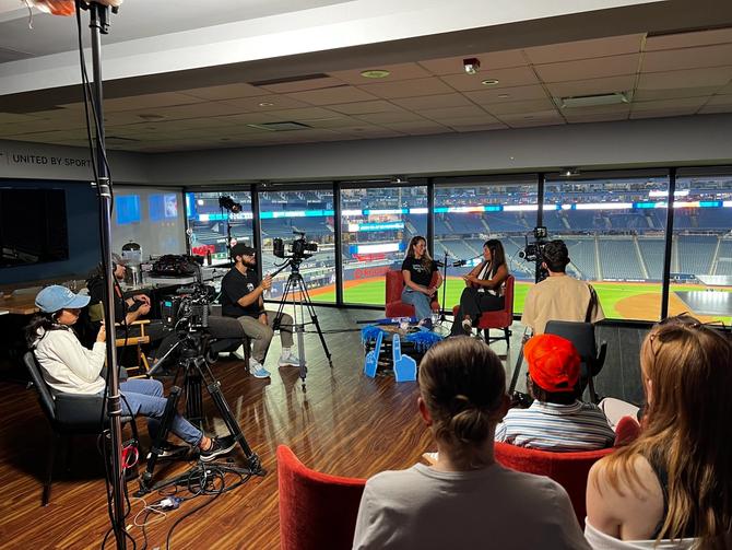 Ellen Hyslop and Hazel Mae chatting in front of a live audience