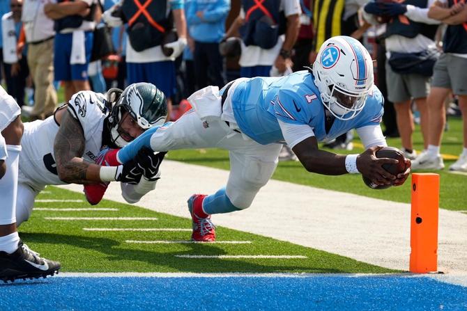 Tennessee Titans quarterback Cam Ward dives for a touchdown.