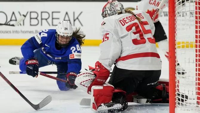 Canadian goaltender Ann-Renée Desbiens blocks a shot by American forward Joy Dunne during Game 1 of the Rivalry Series in San Jose, California.