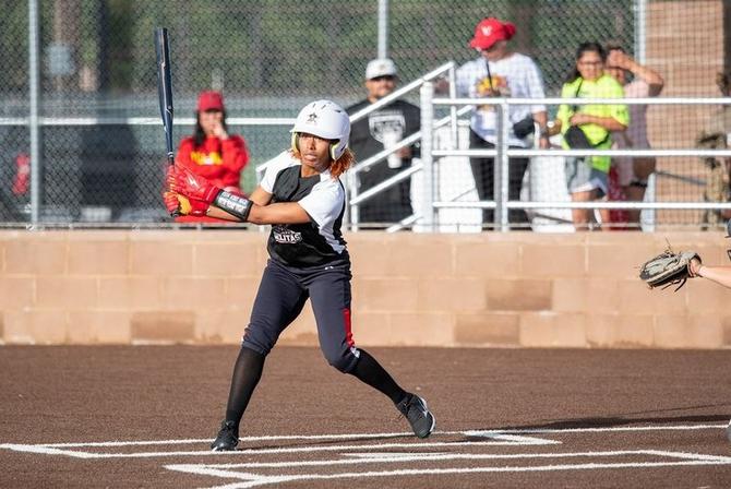 A Hub City Adelitas player swings at a pitch during a game.