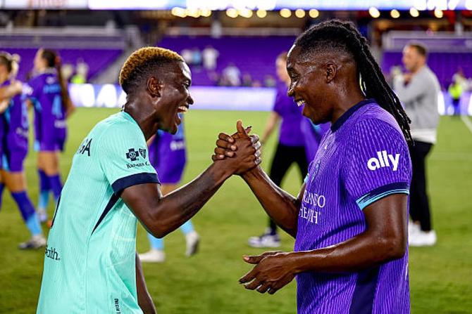 African soccer stars Barbra Banda of the Orlando Pride and Zambian national team and Temwa Chawinga of the Kansas City Current and Malawi talk after an NWSL game in July 2026.