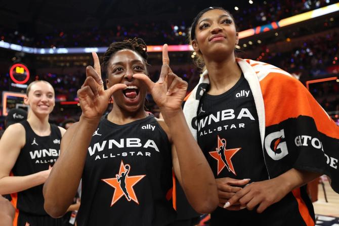 WNBA All-Star Nneka Ogwumike holds her hands up in a W sign during the 2025 WNBA All-Star Game