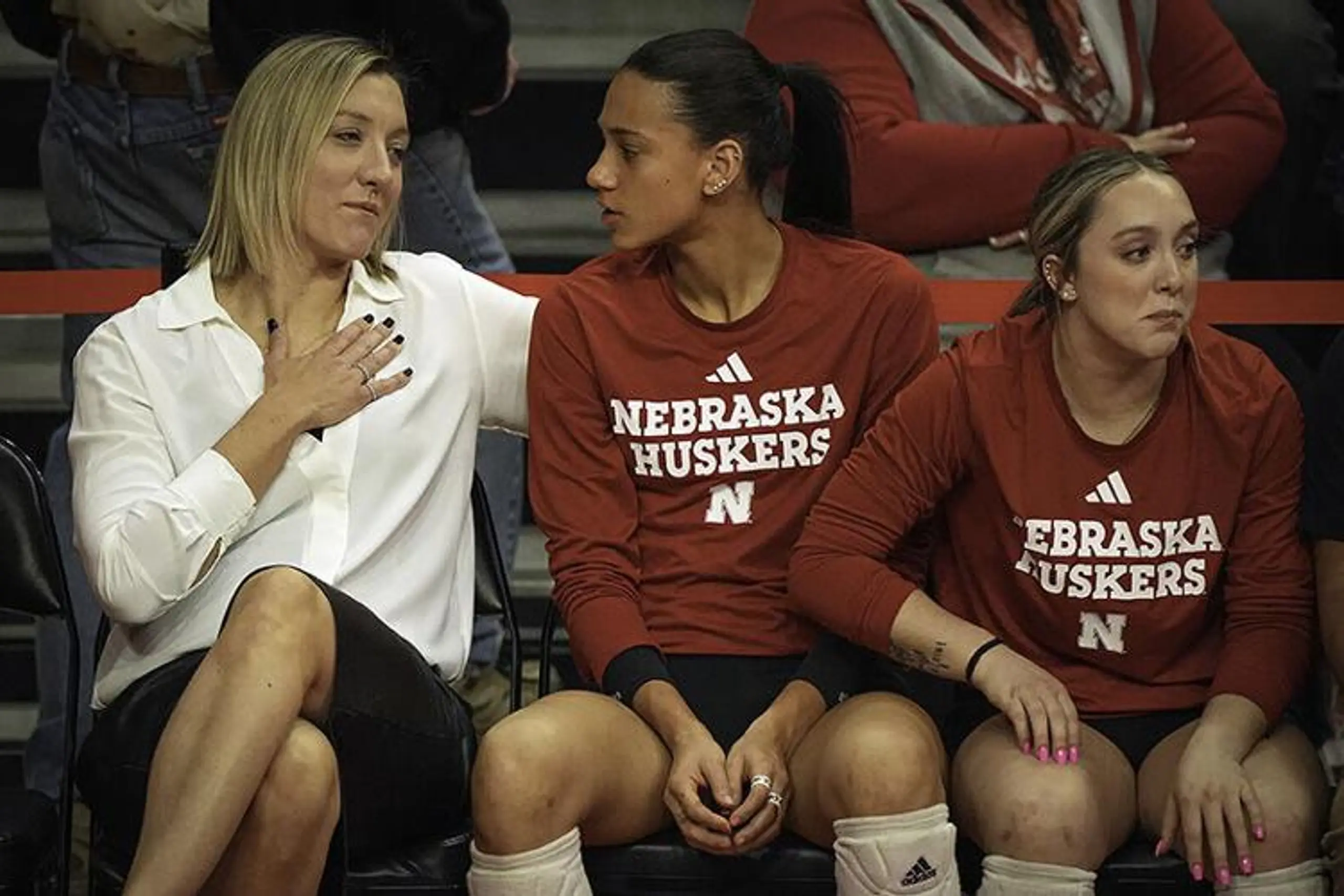 Nebraska women’s volleyball assistant coach Jordan Larson speaks to players on the bench