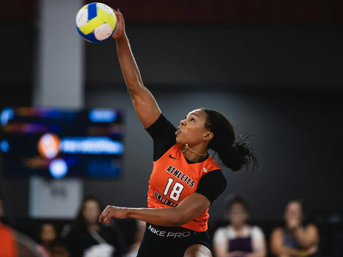 An AU volleyball player spiking a ball