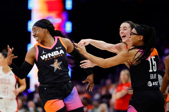 Arike Ogunbowale celebrates a three point basket.