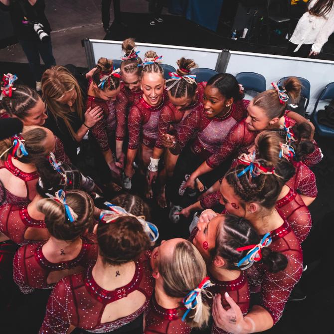 The Oklahoma women’s gymnastics team celebrates a win over LSU, Cal, and Utah.