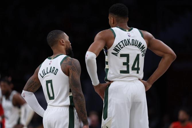 Giannis Antetokounmpo #34 and Damian Lillard #0 of the Milwaukee Bucks look on against the Washington Wizards